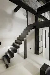 A handcrafted steel staircase connects the two levels. 