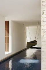 A restored canoe-turned-art piece is suspended above the indoor pool.