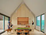In their architectural practice as in their home, Sara and Michael are interested in volumetric play and creating spaces within spaces. The idea shows up in their new kitchen, where a plywood volume with custom millworker pulls away from the walls—like an object within the gabled space.