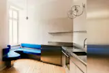 A Curvy Blue Banquette Solves a Tiny Berlin Apartment’s Puzzling Shape