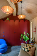 The ceiling-height, curving red cabinets were handmade by the owners.