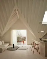 This sculptural ceiling tucks into the corners of a top-floor London home, creating intimate moments, but soars above a mezzanine.