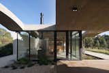 A Wave of Concrete Caps This Glass-Walled Home in Argentina