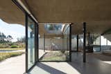A Wave of Concrete Caps This Glass-Walled Home in Argentina