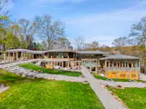 Spanning nearly six acres, the contemporary estate includes a main house, a pair of guest residences, and a saltwater pool.