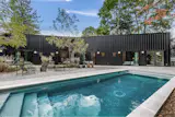 The home is a 10-minute walk from the local beach, and comes with a gunite pool in the backyard.