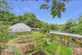 The property is part of the La Ecovilla community, which includes amenities like the Real World School, open-air wellness spaces, and organic gardens crowned by a geodesic dome.