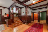 The renovation preserved historic details like the original woodwork, hewn beams, moldings, fireplaces, and a basement vault referencing the history of Navin Field.