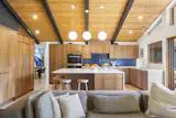 Much of the tile throughout the home is by Heath Ceramics. The custom walnut and oak cabinetry is by Artisan Woodworking.