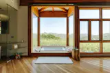 One of the two primary bedroom suites features a soaking tub overlooking the surrounding landscape.