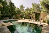 The landscaped backyard has an hourglass-shaped pool and a large patio with space for dining and lounging.&nbsp;&nbsp;