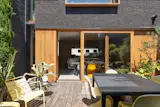 The house is composed of three volumes—two square-shaped and one rectangular—linked by glazed connections. 