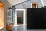 The extension preserved the home’s structural black brickwork. 