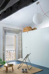 The Staircase in This Renovated Spanish Flat Is Also a Storage Unit—and a Kitchen