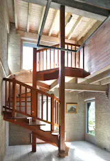 The wood, brick, and tile interiors are a warm complement to the iridescent exterior.&nbsp;