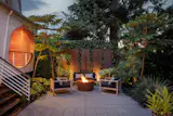 Michael Schultz designed the multilayered backyard garden, framed by towering cedars, Douglas firs, and palms.