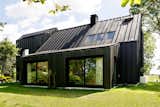 Instead of Tearing Down Their ’70s Farmhouse, They Wrapped It in Black Cladding