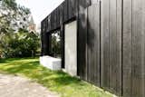 Instead of Tearing Down Their ’70s Farmhouse, They Wrapped It in Black Cladding