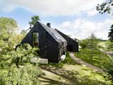 Instead of Tearing Down Their ’70s Farmhouse, They Wrapped It in Black Cladding