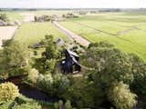 Instead of Tearing Down Their ’70s Farmhouse, They Wrapped It in Black Cladding