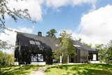 Instead of Tearing Down Their ’70s Farmhouse, They Wrapped It in Black Cladding