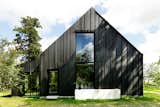 Instead of Tearing Down Their ’70s Farmhouse, They Wrapped It in Black Cladding
