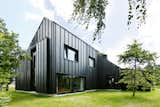 Instead of Tearing Down Their ’70s Farmhouse, They Wrapped It in Black Cladding