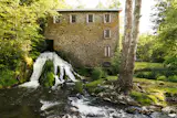A Waterfall Rushes Through This $5.25M Mill Turned Residence in Upstate New York