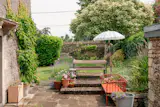 Surrounded by stone walls, the garden wraps around the front and western sides of the house.&nbsp;