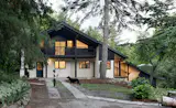 A Massive New Roof Turns a ’70s Chalet in Canada Into a Forest Palace