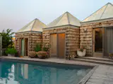 Across from the main home, three pyramidal structures contain two guest bedrooms and a shared bath.