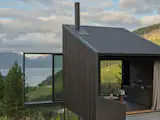 This New Zealand Tiny Cabin’s Glass Sliders Are So Big They Hang Off the Side