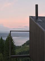 This New Zealand Tiny Cabin’s Glass Sliders Are So Big They Hang Off the Side