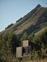 This New Zealand Tiny Cabin’s Glass Sliders Are So Big They Hang Off the Side