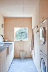 Laundry Room, Stacked, Stone Counter, and Wood Cabinet  Photo 4 of 8 in Laundry Room by Ryan Schmitt from House on a Ridge in Maine