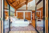 Your expansive primary retreat opens to a wooded deck in a serene & natural setting, equipped with wood burning stove, vaulted ceilings & a beautifully updated attached full bath. 