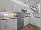 European style cabinets in renovated kitchen. New dishwasher pictured
