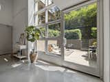 Floor to ceiling windows show off your private oasis in an urban environment