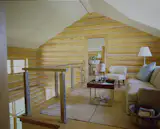 For the sitting area on the upstairs landing, between the two bedrooms, Wolf created an industrial strength balcony railing of steel rods and and tension wire.  The space is extremely safe and visually open to the public spaces.