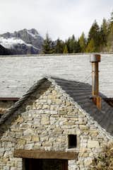 Exterior, Tile Roof Material, House Building Type, Wood Siding Material, Stone Siding Material, and A-Frame RoofLine The slate roof mirrors the surrounding landscape  Photo 7 of 53 in House Cinsc - a retreat among the peaks by ATOMAA