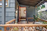 Back porch used as the main entrance. Reclaimed wood floors.