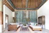 View of Living Room:Hand Madura Sourced carved Panel and hand laid 30ft tall Thatch roof.