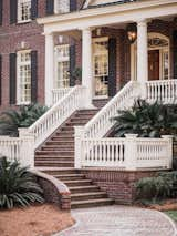 The entrance of the home boasts beautiful red brick. 