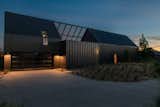 Exterior, Cabin Building Type, Metal Roof Material, A-Frame RoofLine, and Metal Siding Material Desert Cabin Front Exterior - Night  Photo 2 of 12 in Desert Cabin by Mark Bragen