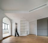 Curved shelving aims to integrate the preexisting angled geometries to the softer arcs of the apartment.