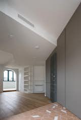 All the areas are visually connected by the ceiling treatment and the use of color across the storage closets, which are hidden in the west wall.