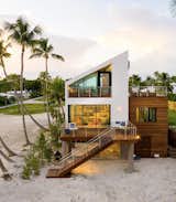 Exterior, House Building Type, Concrete Siding Material, Green Roof Material, and A-Frame RoofLine Ocean side of home with Ipe wood cube and juxtaposition high pitch roof.   Photo 2 of 12 in Ocean Front Contemporary Beach House, Islamorada. by Louis Sena