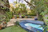 This private and lush enclosed oasis has a keyhole shaped hot tub/plunge pool,  yard and outdoor barbecue for entertaining.