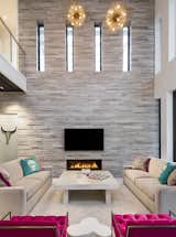 Living Room, Gas Burning Fireplace, Sofa, Pendant Lighting, Coffee Tables, and Chair  Photo 4 of 11 in Two Story Modern Architecture by BUILD LLC