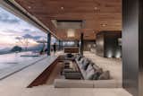 A swimming pool spans the entire length of the home’s communal spaces, ensuring that the ocean view can be taken in from the living room, dining room, open kitchen and games room.